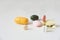 Pills in a row, various forms, white background. Multi-colored pills close-up and copy space