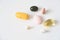 Pills in a row, various forms, white background. Multi-colored pills close-up and copy space