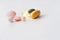 Pills in a row, various forms, white background. Multi-colored pills close-up and copy space