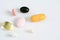 Pills in a row, various forms, white background. Multi-colored pills close-up and copy space