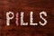 Pills sign on wood background