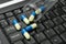 Pills spilled on black laptop keyboard