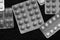 Pills and tablets blisters on a dark background black and white
