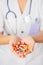 Pills, tablets and drugs heap in doctor\'s hand