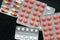 Pills and tablets packages on a dark background