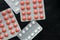 Pills and tablets packages on a dark background