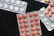 Pills and tablets packages on a dark background
