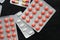 Pills and tablets packages on a dark background