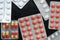 Pills and tablets packages on a dark background