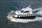 Pilot boat escorting cruise ship out of harbor at Port of Civitavecchia, Italy, the Port of Rome