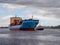 A pilot boat is guiding a large loaded container ship along the fairway