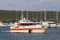 Pilot boat sails the waters of the marina among moored sailing yachts. Assistance in mooring the vessel in the seaport. Coast