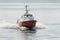 Pilot boat on steely gray water