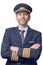 Pilot in captain uniform with 4 golden stripes and cap crossed his arms