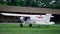 Pilot checking private plane standing green airfield. Making preflight procedure