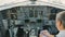 Pilot checks doments sitting in cockpit