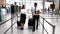 Pilot and female flight attendant walking with luggage