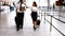 Pilot and female flight attendant walking with luggage