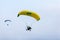 The pilot flies on a motorized parachute at a hot air balloon feThe pilot flies on a motorized parachute at a hot air balloon fest