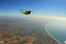 Pilot. Fly men is a pilot of his body in air. Extreme people prefer skydiving. Parachutist in green suit. Free lifestyle