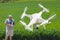 Pilot Flying Drone Gathering Data Over Country Farmland Field