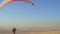 The pilot on the paraglider catches the tailwind