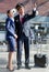 Pilot pointing aircraft while talking to flight attendant in airport