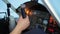 Pilot\'s hand knocking on breakdown cockpit panel, flight control system error