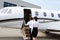 Pilot and stewardess entering private jet
