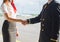 Pilot and stewardess shaking hands.