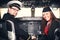 Pilot and stewardess sitting in an airplane cabin