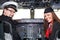 Pilot and stewardess sitting in an airplane cabin