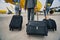 Pilot and stewardesses with luggage walking towards the landed aircraft