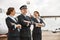 Pilot and stewardesses on runway near airplane jet