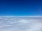 pilot view from aircraft cockpit over white cloud ceiling in stratosphere