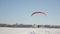 The pilots of the paraglider are rising into the air. Competitions of paragliders on the frozen lake. Ternopil Ukraine