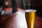 Pilsner beer glass on a table