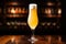 pilsner beer in a tall, slender glass, light behind it