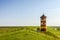 Pilsum Lighthouse on the Dike on the East Frisian North Sea Coast, Germany