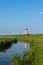 Pilsum Lighthouse with Reflection in Water, East Frisia,Lower Saxony, Germany