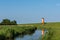 Pilsum Lighthouse with Reflection in Water, East Frisia,Lower Saxony, Germany