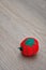 A pin cushion shaped as a red tomato