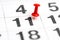 Pin on the date number 11. Eleventh day of the month is marked with a red thumbtack. Pin on calendar