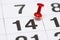 Pin on the date number 14. The fourteenth day of the month is marked with a red thumbtack. Pin on calendar
