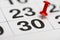 Pin on the date number 30. The thirtieth day of the month is marked with a red thumbtack. Pin on calendar