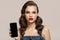 Pin-up girl holds smartphone in hand