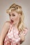 Pin-up style portrait of surprised blonde woman