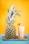 pina colada alcoholic cocktail with rum, pineapple and ice on yellow and blue background