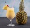 Pina Colada over wooden background garnished pineapple. A cocktail