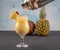 Pina Colada over wooden background garnished pineapple. A cocktail